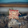 Monedero de tela acolchado con estampado de flores rojas confeccionado artesanalmente.