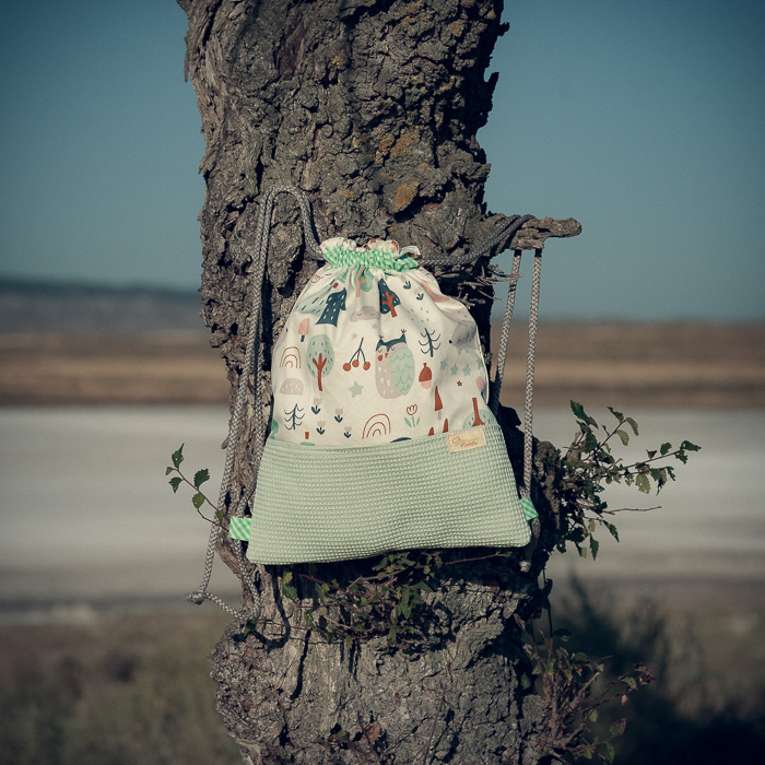 Mochila infantil pequeña de tela con estampado de bosque y zorritos hecha a mano.