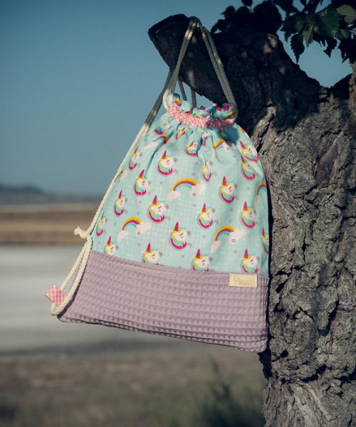 Mochila infantil grande de tela con estampado de unicornios sobre fondo azul hecha a mano.
